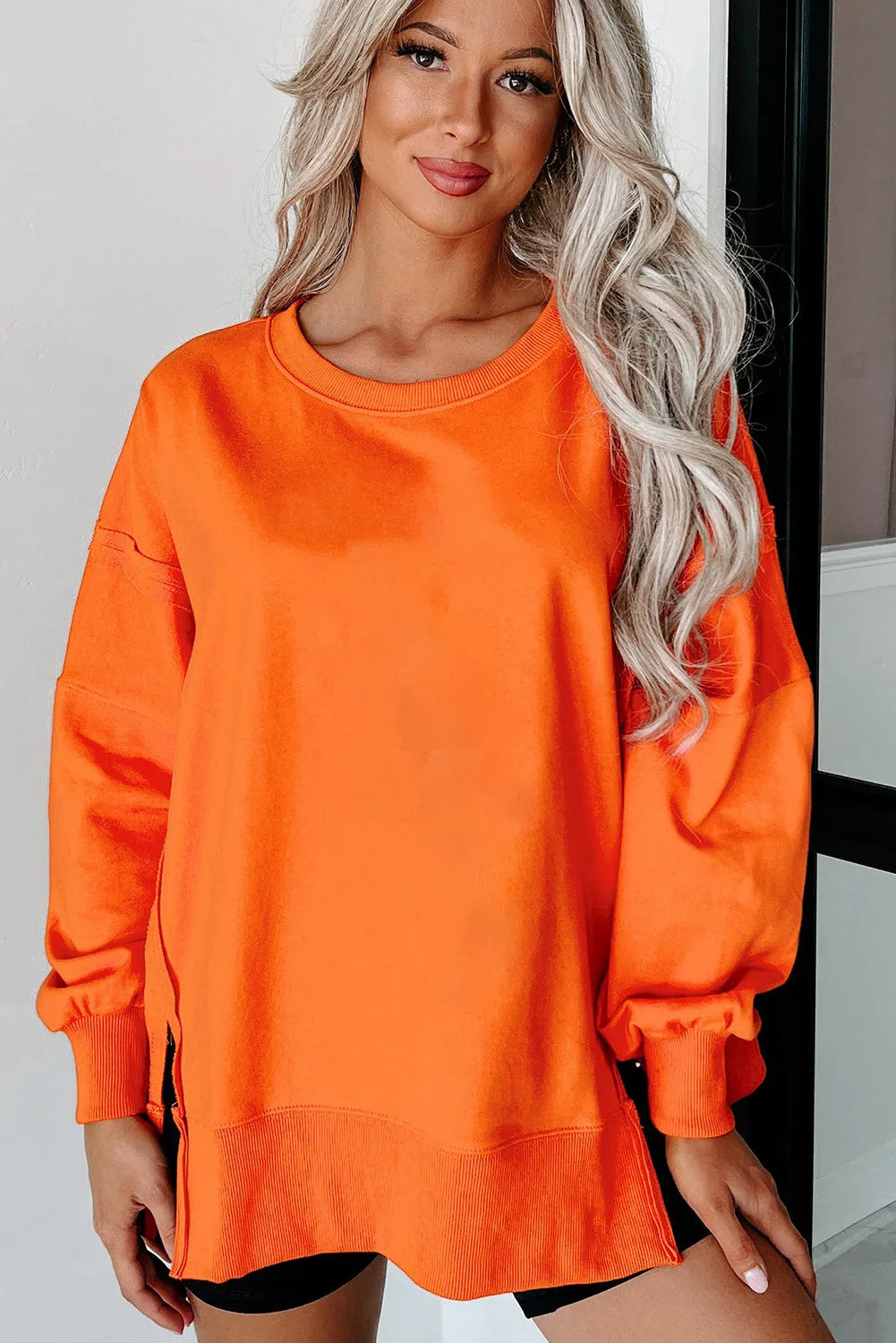 Carrot Exposed Seam Drop Shoulder Round Neck Sweatshirt with Slits - Chic Meadow Boutique 